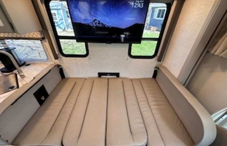Dinette folded down into bed and Dinette smart TV.