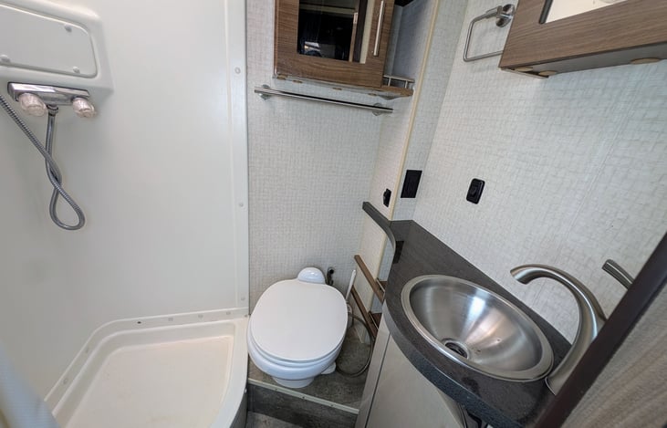 Comfortable and spacious bathroom with shower.