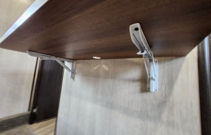 Private bedroom work desk and controls.