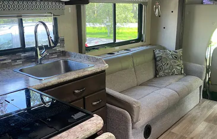 Sofa, many outlets for charging, cup holders everywhere! Pull down faucet, stove and oven. Lots of storage.