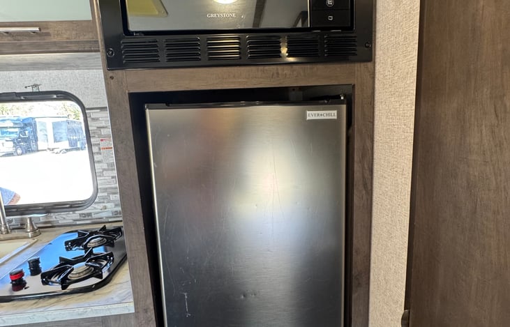 Medium size fridge and microwave with easy access.