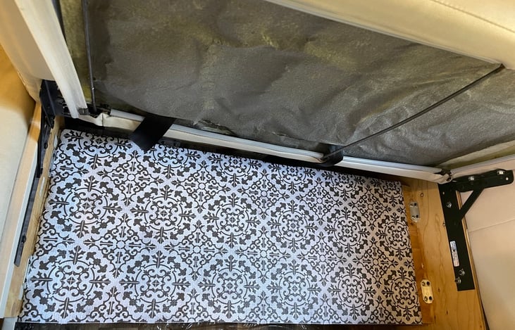 This is one two spaces of about the same size under kitchen dinette seats for food storage.