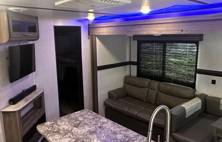 Living area with smart TV, fireplace, and sound bar