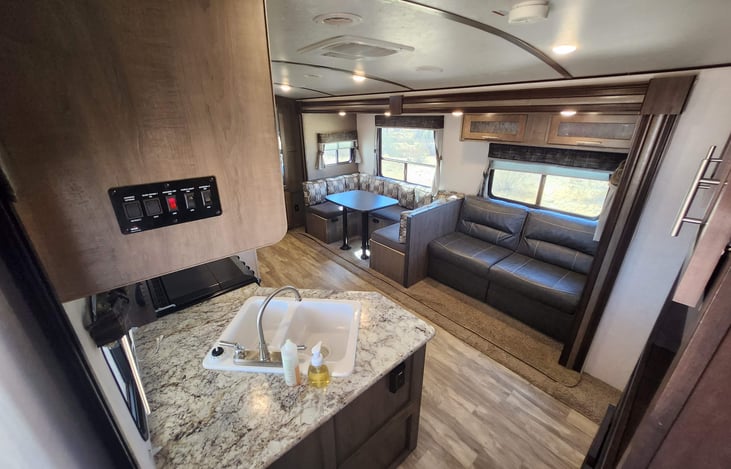 A look at the spacious living room, dinette, and kitchen with plenty of storage from the front door.