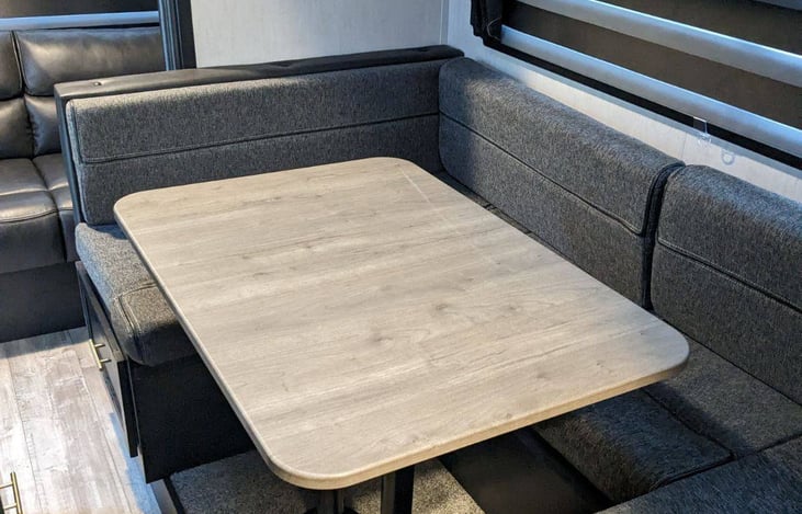 U shaped kitchen dinette folds into a queen bed with slide out.