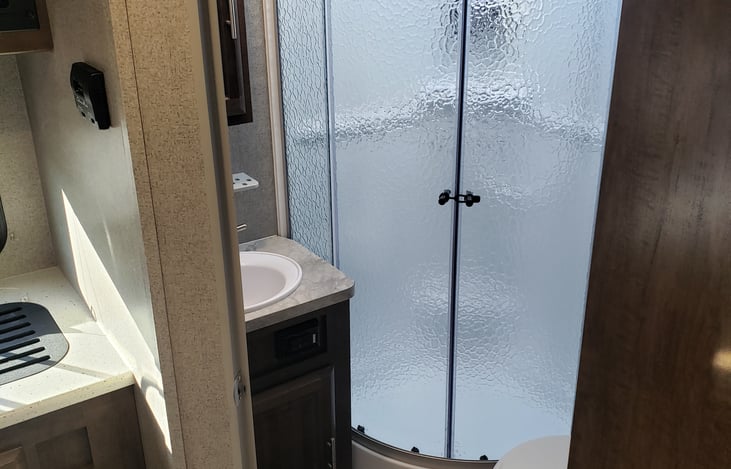 Bathroom - sink, stand-up shower, toilet.  Plenty of storage in the linen closet, medicine cabinet and under sink.