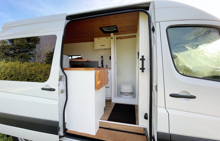 Handle assist to step into van. Stovetop faces towards open door for complete immersion in nature and a great view while prepping your meal.
