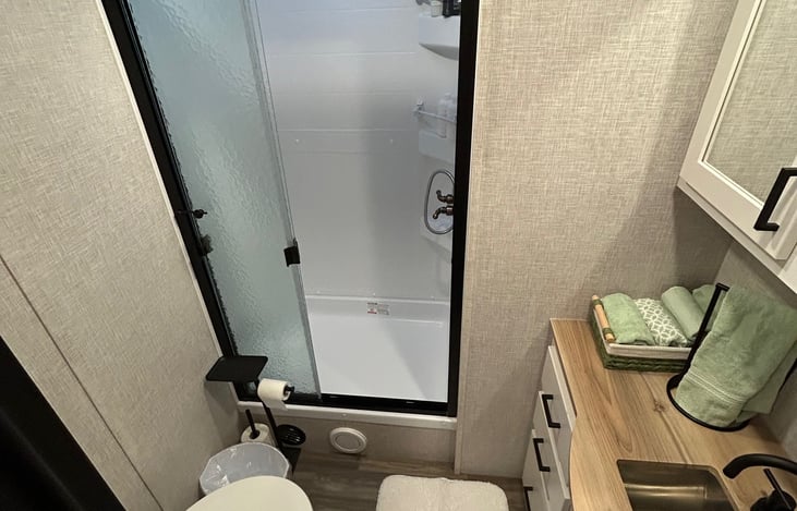 Comfortable private bath with plush towels (including beach towels), toiletries, blow dryer, makeup wipes, and adjustable spray shower head.