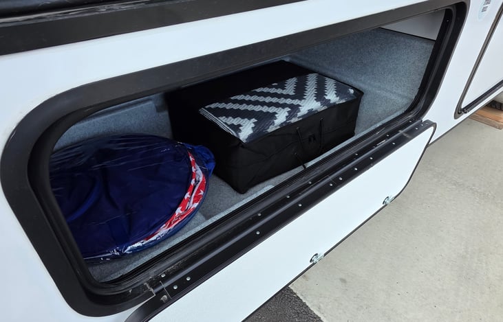 Outdoor rug, trash can, and games