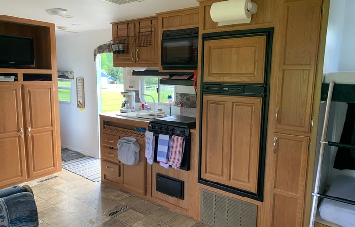Full kitchen w/ coffeemaker, plates, bowls, cups,utensils and food storage bowls. Also salt and pepper, cream/sweetener, oven mitts, and lemon and lime packs, bottle/wine/can opener