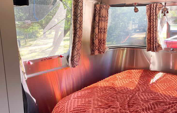 This glamping Airstream rental has high vibrational decor along with soft fabrics and fluffy pillows to add comfort. Linens included are fresh sheets and pillowcases with master bedding and twin bed.