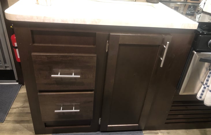 Kitchen drawers and door under sink with storage