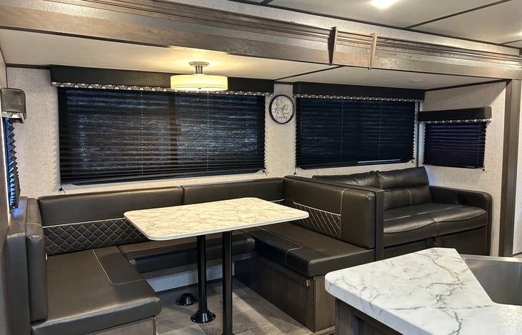 Pull out couch and convertible dining area will sleep two additional small bodies each, for a total of four.