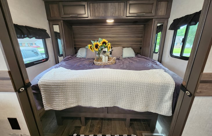 Master bedroom with storage and a KING BED, double pocket doors for privacy.