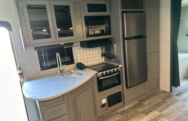Kitchen area includes dinnerware, pots, and pans and silverware.