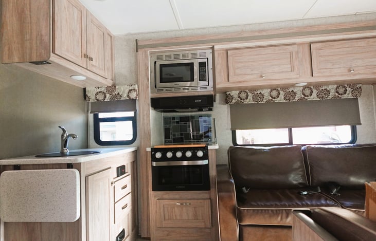 L shape kitchenette! has extra extendable counter space, 3 burner stove, oven and microwave.