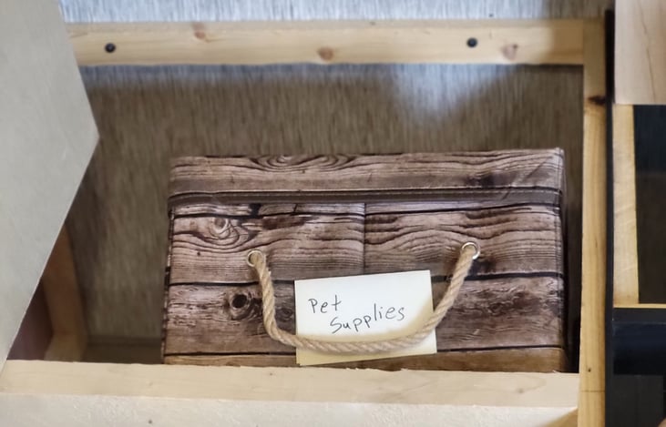Under dinette storage, showing pet supply bin.