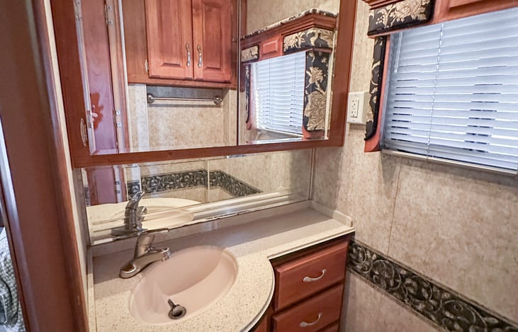 Huge vanity in bathroom and medicine cabinet so two people can get ready at once.