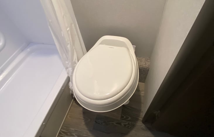 Bathroom has a stand up shower and toilet.  Sink is outside of the bathroom.