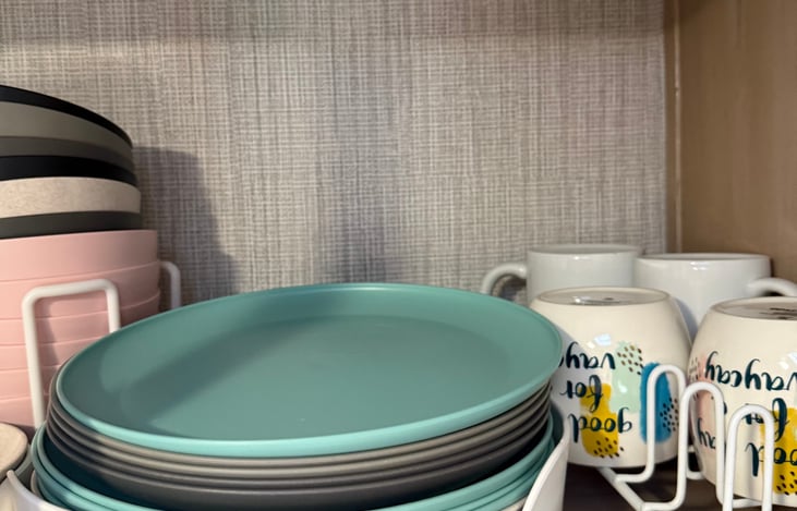 Fully stocked dishware including plates, bowls, drinkware, mugs, and prep boards — ready for everything from quick snacks to full meals.