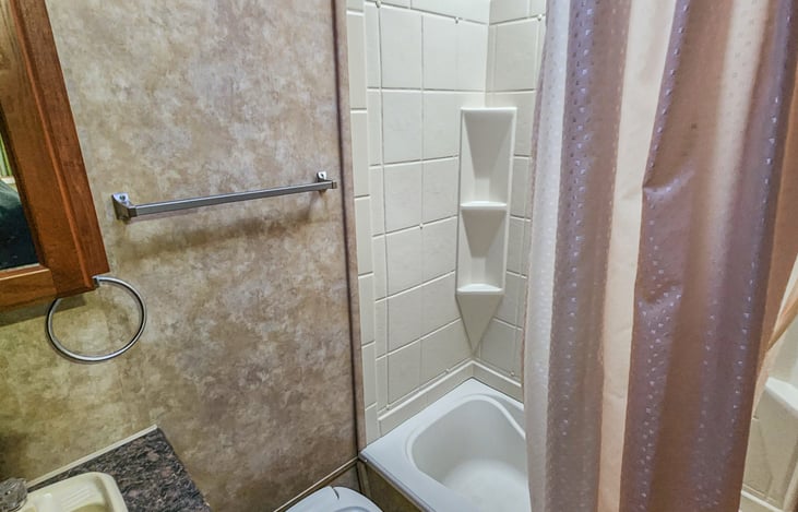 Full bath with tub shower.