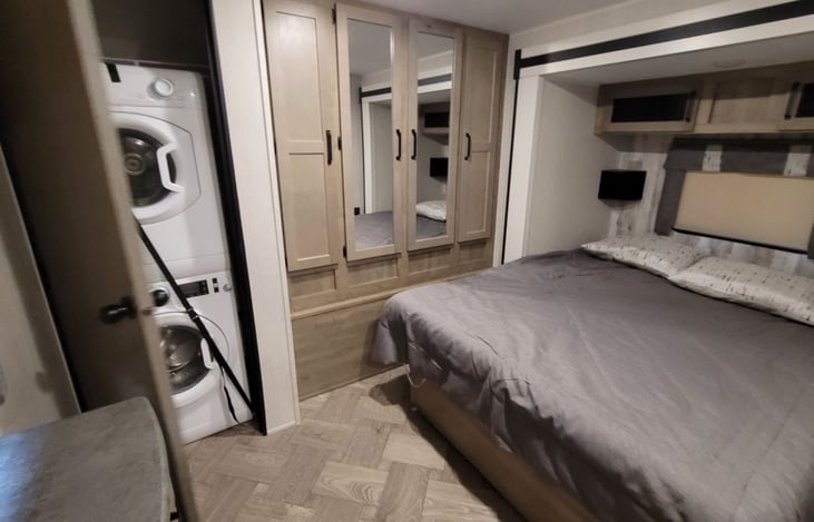 Master bedroom. Queen size bed. Plenty of storage behind the mirror doors. Rack to hang your clothes as well.   Stackable washer and dryer as well