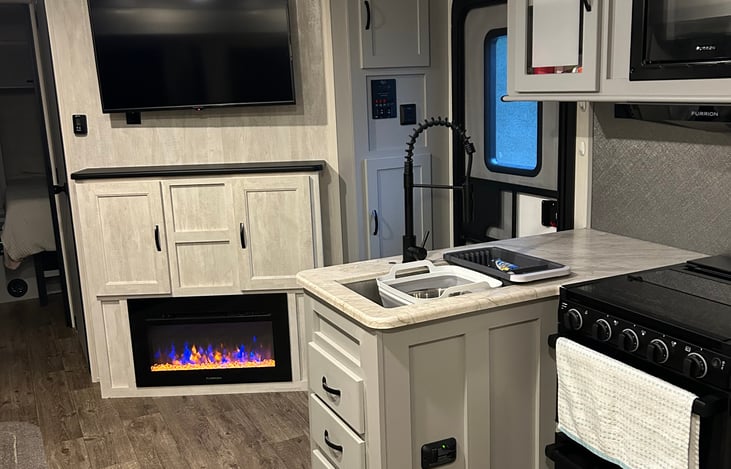 This is your view from the back side of the camper. The cozy fireplace is perfect for the cooler months, and the layout gives a great open feel to the space