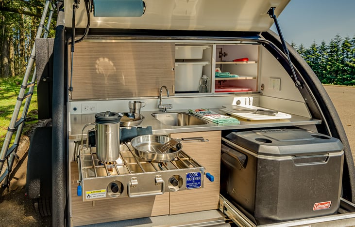 Cooking is so easy with the Galley Kitchen -- Pots, Pans, Plates, Cups, Utensils all included. NOTE: 40L Electric Fridge Included in Rental (but not shown in photo)