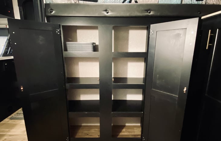 Multiple storage shelves in the bunkroom.