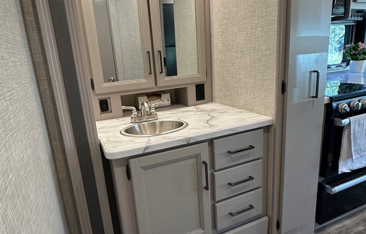 Sink and mirror outside of the main bathroom.