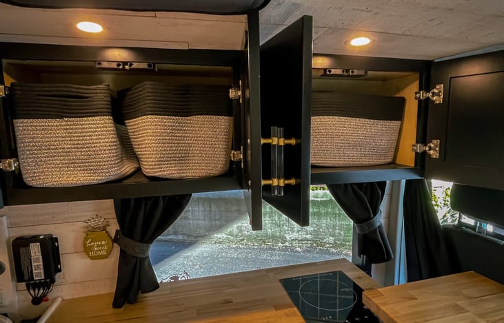 Overhead cabinets with soft baskets to keep things in place while driving.