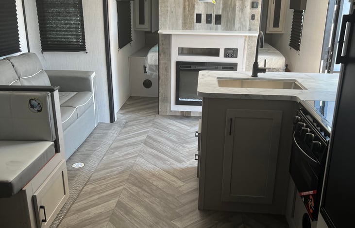 Kitchen with stove, fridge, sink, oven/airfryer,  and 3 burner stove