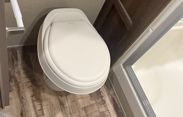 Toilet, towel closet next to the shower