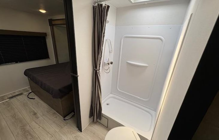 Shower.. Also has a curved curtain rod for additional maneuverability