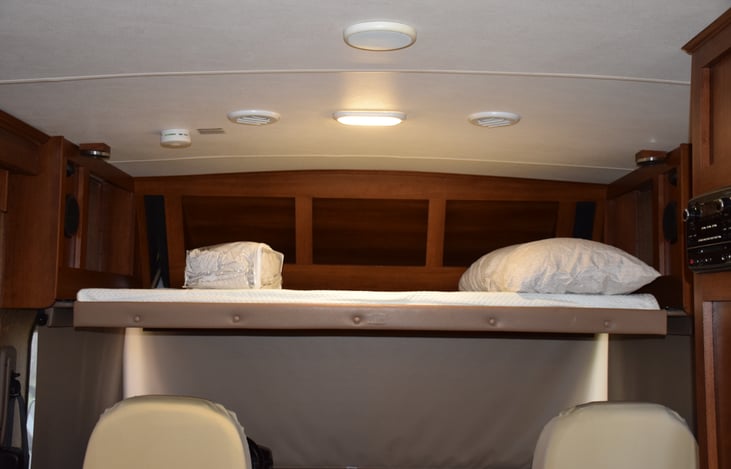 Queen size bed! linens and pillows provided. Raises when not in use.