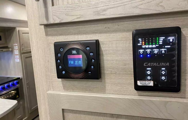 Control panel with easy-to-read display.  Turn on the lights inside and out.  You can also turn on the hot water heater and the water pump from this panel. You turn on the radio here too,