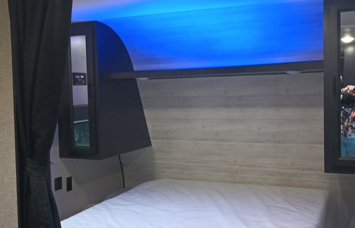 It has neon blue lights in bedroom, stove and outside. As you see in picture.