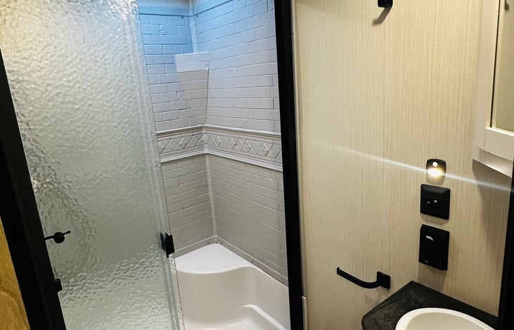 Shower has curtain with liner (not sliding doors)