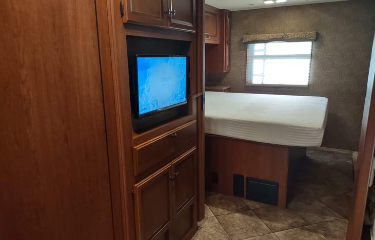 TV/DVD next to bathroom faces the bunk beds/sofa