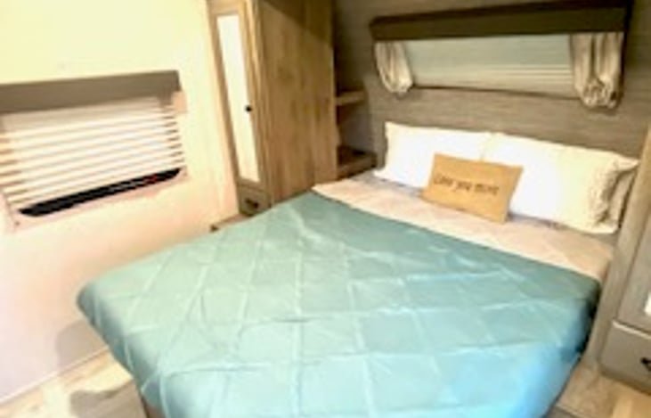 Upgraded queen mattress in private bedroom with windows and storage.