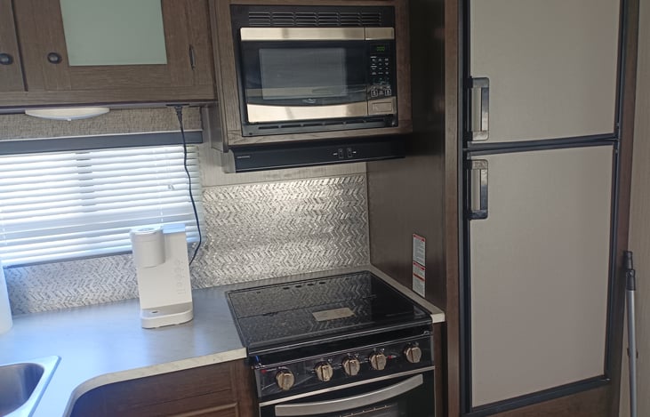Kitchen... Notice that glass is only down when you are NOT cooking to create more counter space. Keurig coffee maker shown