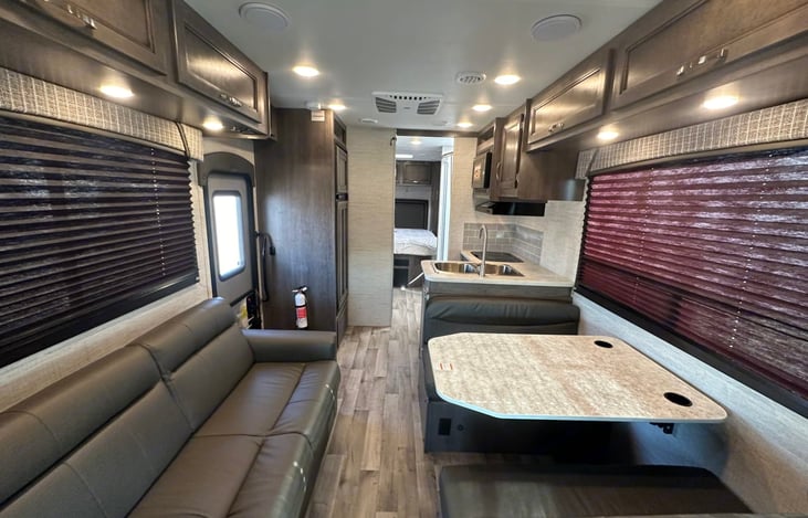 Dinette also converts to a bed.  There are 2 lapbelts on the couch and 4 on the dinette.