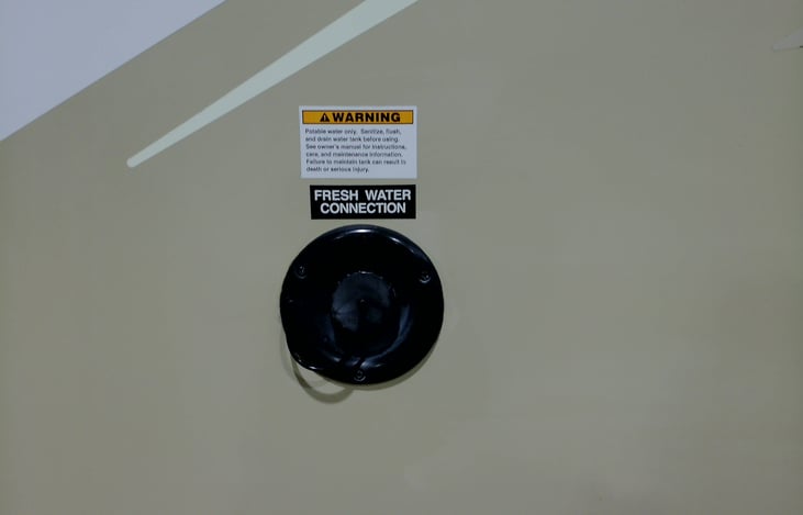 Fresh water connection on left side of RV.
