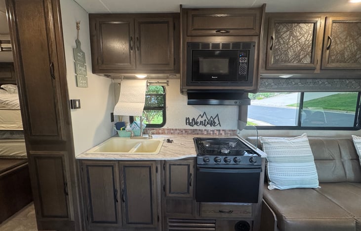 Kitchen with double sink, oven and stove.