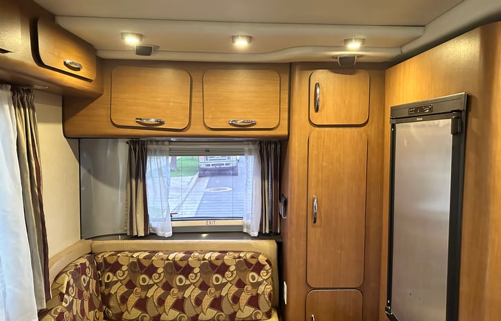 Modern light fixtures and speaker setup make this living area cozy and fun!