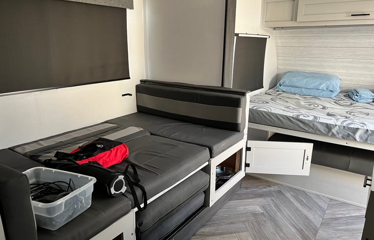 Murphy bed, converted dinette bed, provided cables, Bluetooth speaker and pots and pans below dinette.