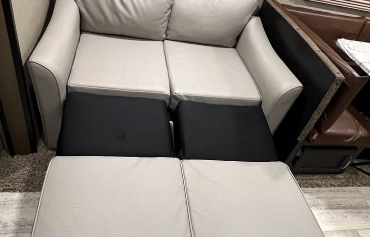 Sofa pulls out to form another place to sleep.