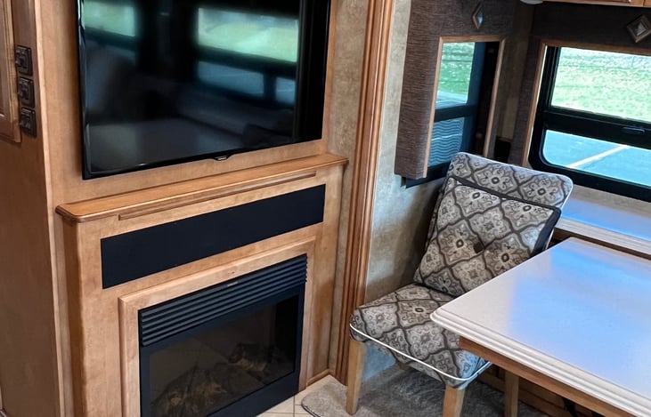 TV, Fireplace and table with chairs