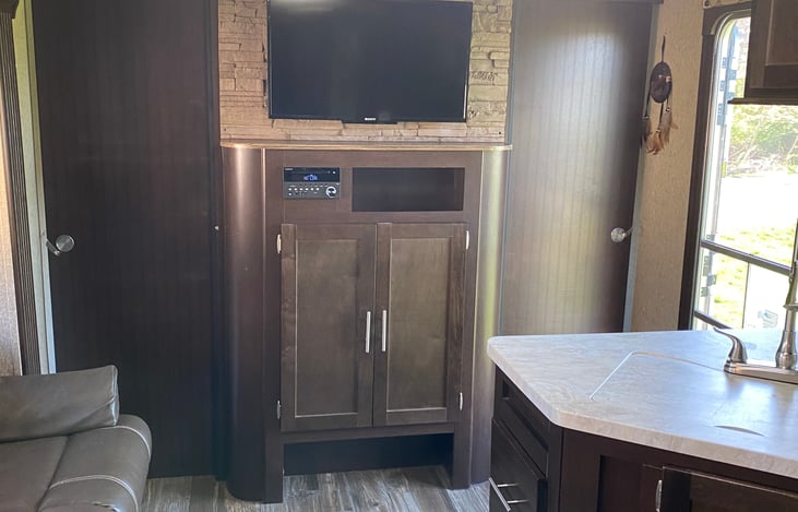 Entertainment center with radio, CD, DVD, Sony TV, cable capability.