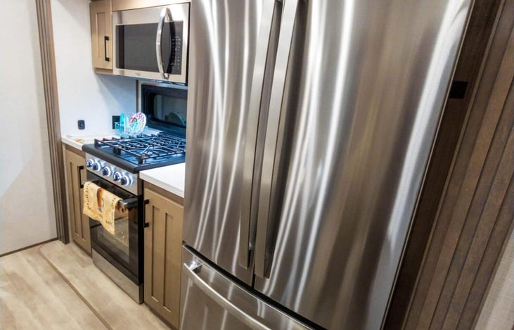 Kitchen with center island and residential fridge